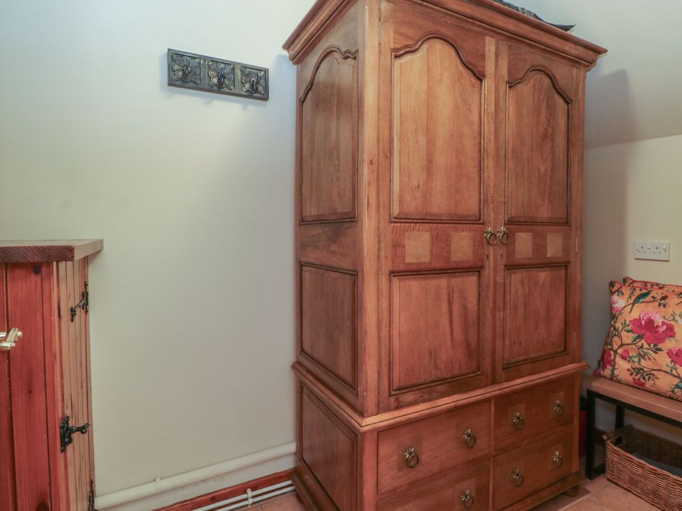 A wardrobe and furniture in a bedroom at Pearls Farm One Wildboarclough near Macclesfield