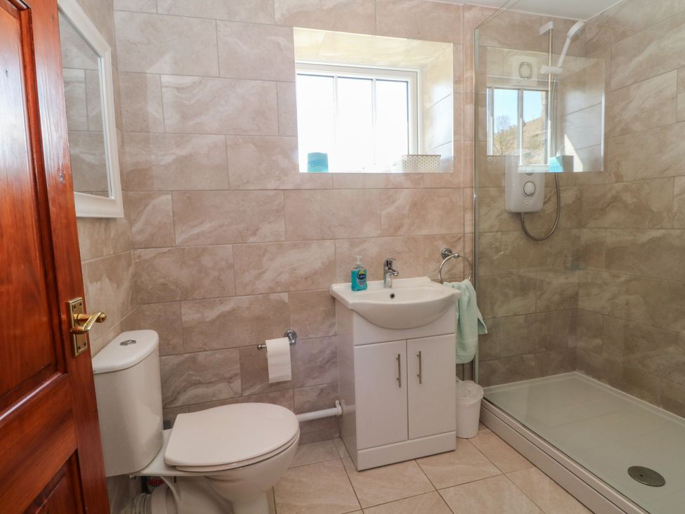 A bathroom with shower, sink, and toilet at Pearls Farm One in Wildboarclough near Macclesfield