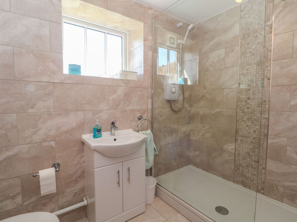 A bathroom featuring a shower with glass door and a sink at Pearls Farm One in Wildboarclough near Macclesfield