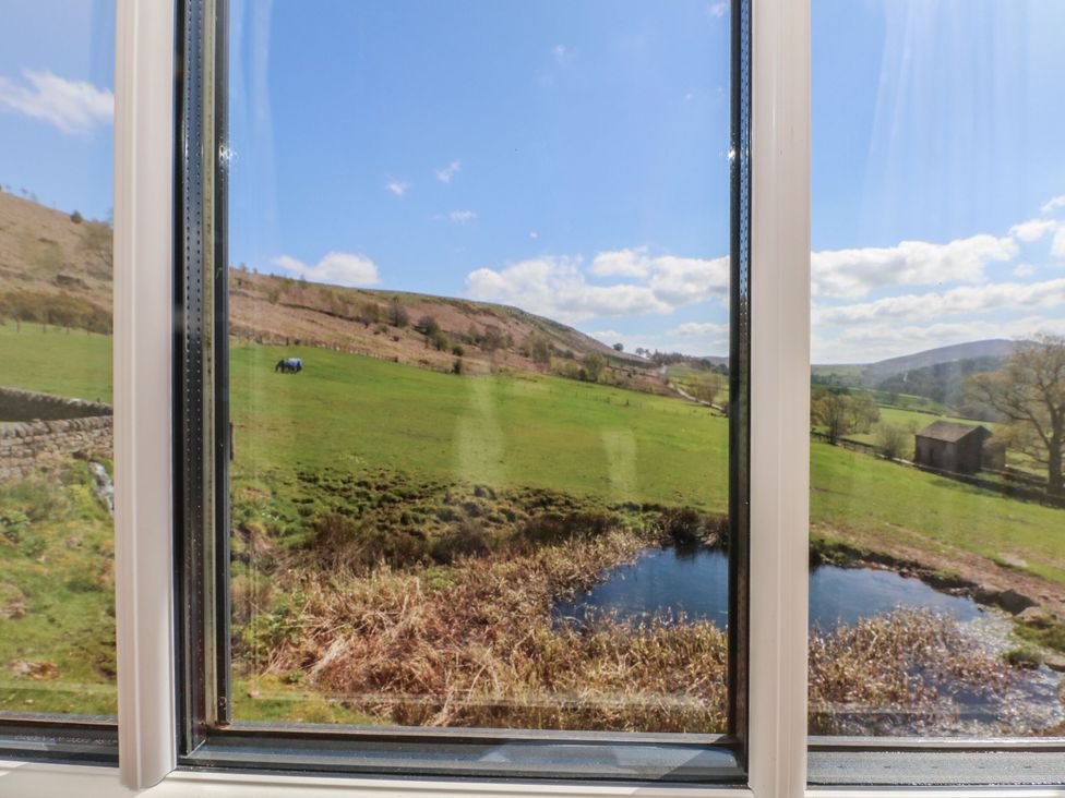 View of hills and field with a pond from a window at Pearls Farm One Wildboarclough near Macclesfield