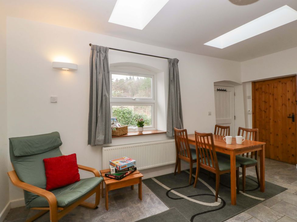 A dining room with a table and chairs at Castle Rag in Lydney