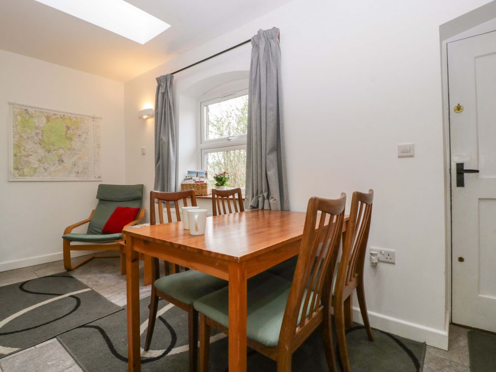 A dining room with a table and chairs at Castle Rag in Lydney