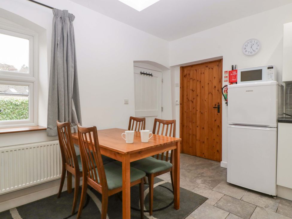 A kitchen with dining table and chairs at Castle Rag in Lydney