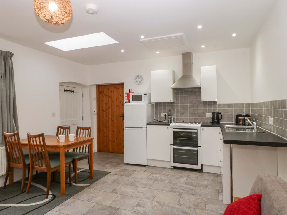 A kitchen with a table and chairs at Castle Rag in Lydney