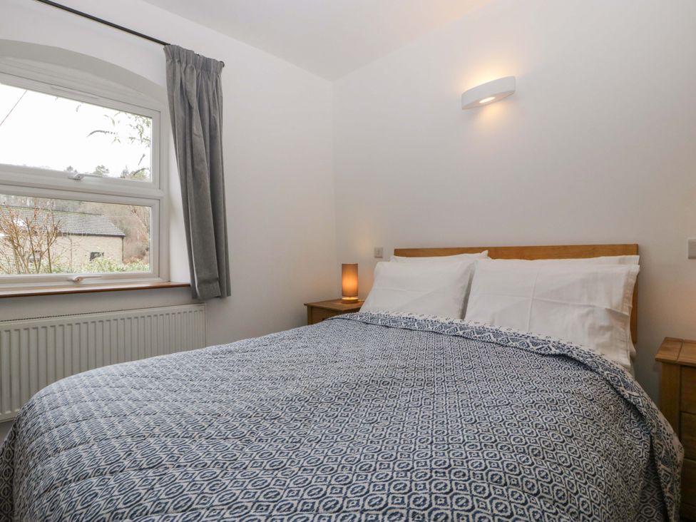 A bedroom with a bed and lamp at Castle Rag in Lydney