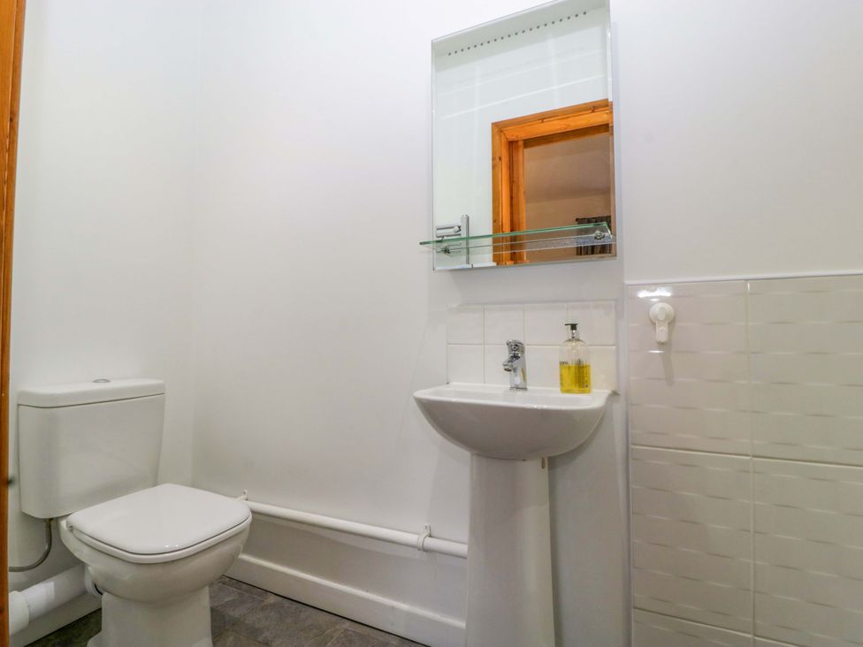 A bathroom with a toilet and sink at Castle Rag in Lydney
