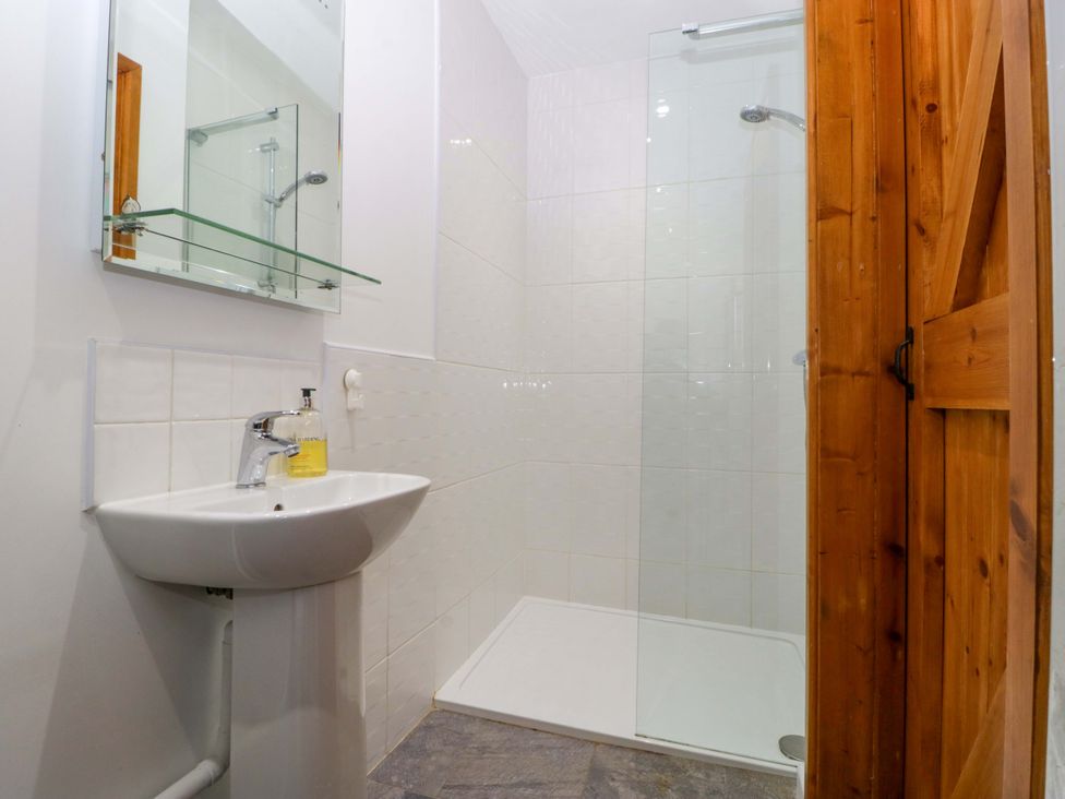 A bathroom with a wash basin and shower at Castle Rag in Lydney