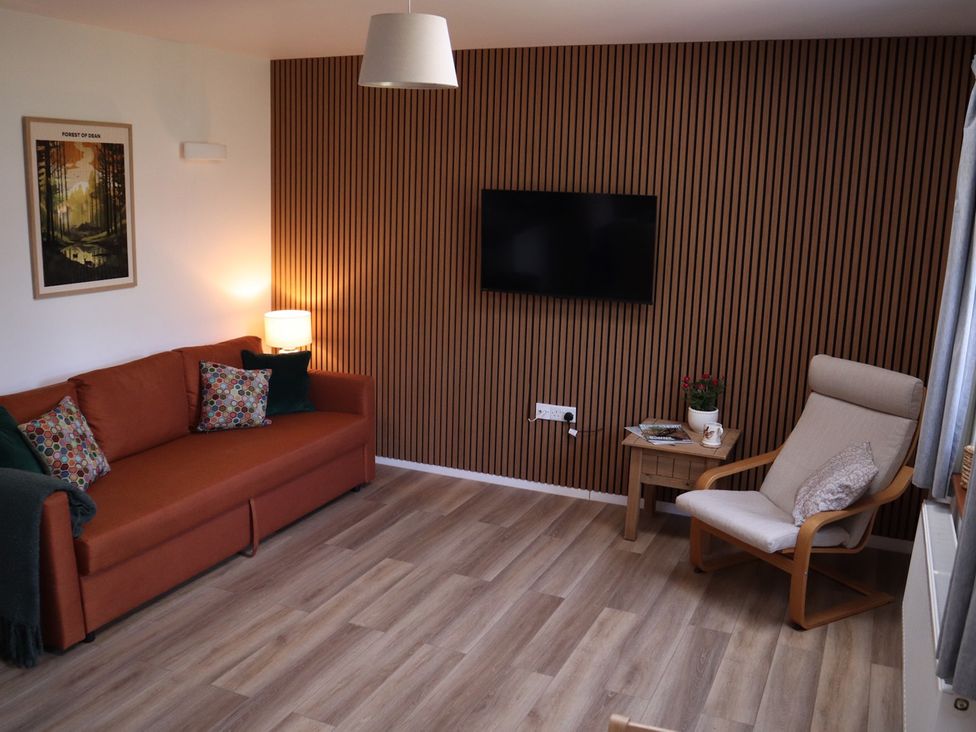 A living room with a sofa and television at Castle Rag in Parkend