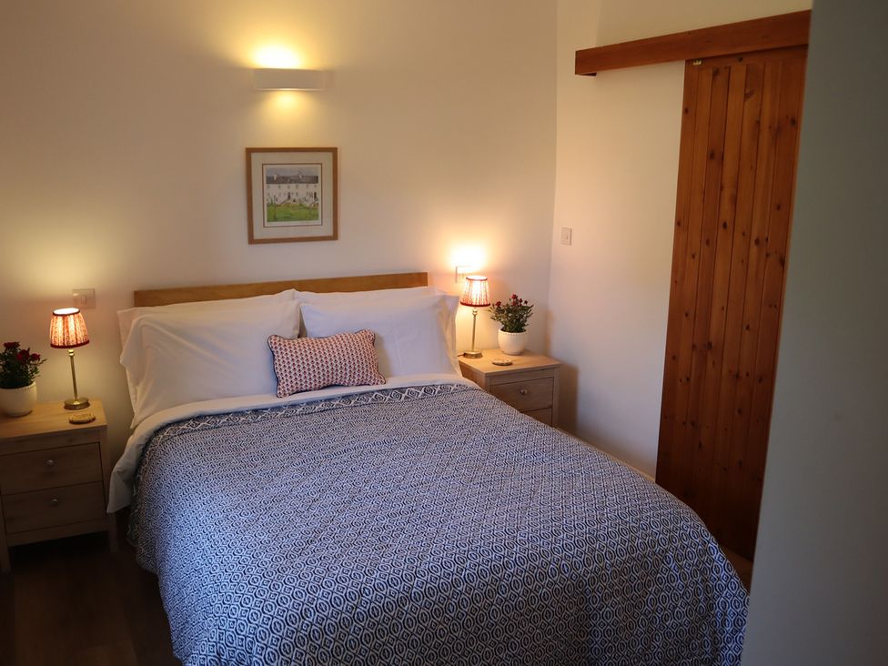 A bedroom with a bed and bedside tables at Castle Rag in Parkend