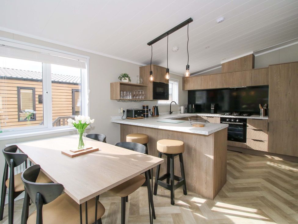 A kitchen with a table and chairs at Tulip in Eardisland