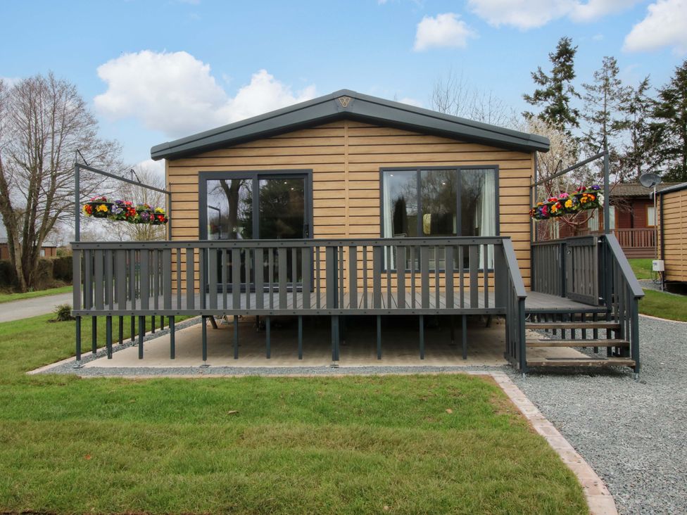 A house with a deck and flowerpots at Poppy in Eardisland