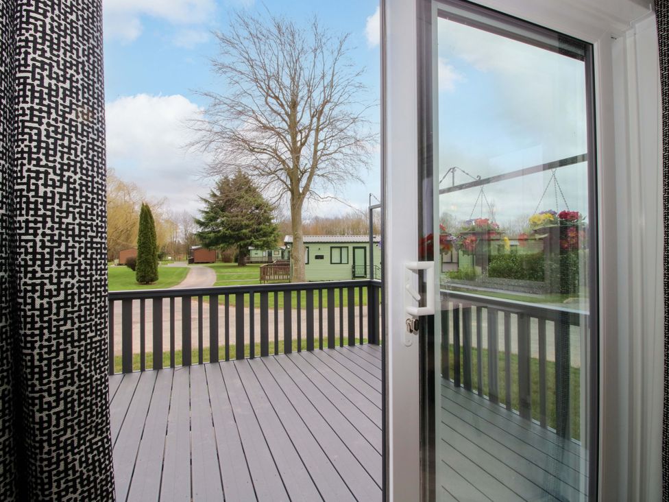 A view from a door onto a deck area at Poppy in Eardisland