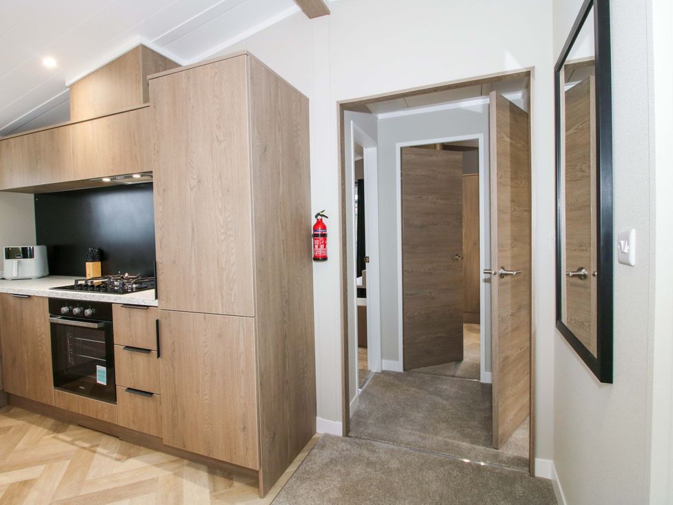 A kitchen with cabinets and an oven at Poppy in Eardisland