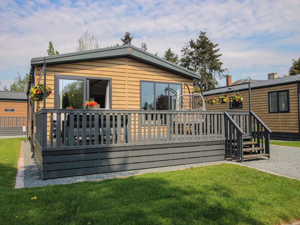A house with a deck and flower pots at Poppy in Eardisland