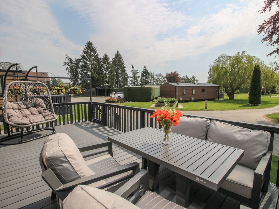 A patio with a table and chairs at Poppy in Eardisland