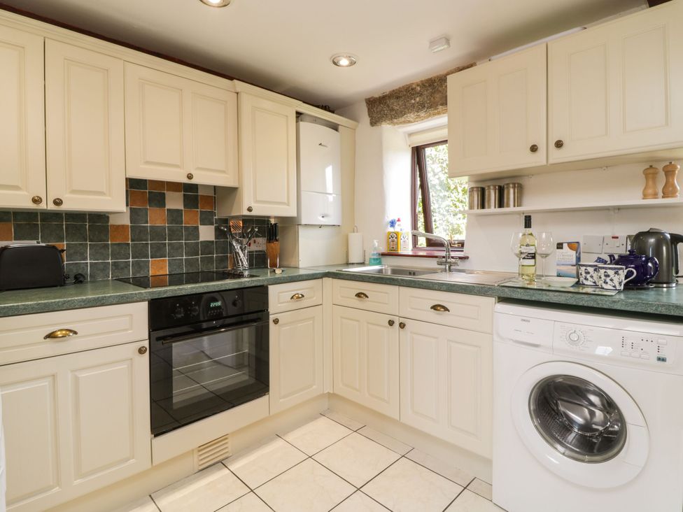 A kitchen with cabinets and appliances at Applestore in Wadebridge