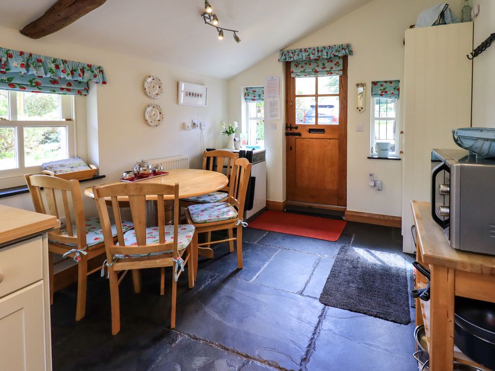 A kitchen with a table and chairs at Beckside Studio Penrith