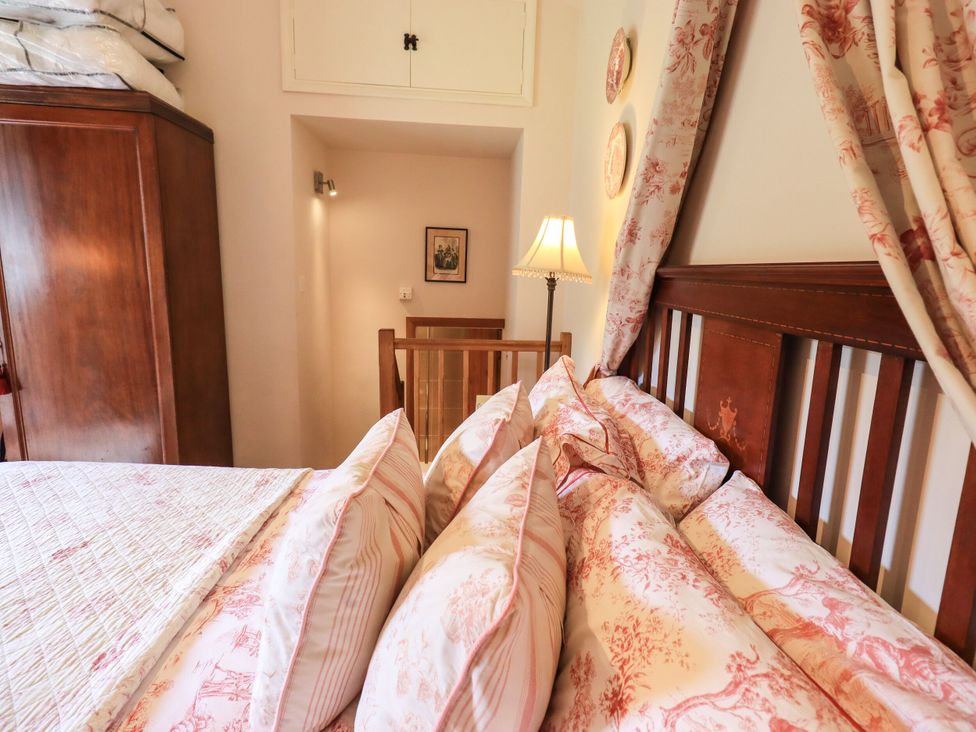 A bedroom featuring a bed with pillows and a wardrobe at Beckside Studio Penrith