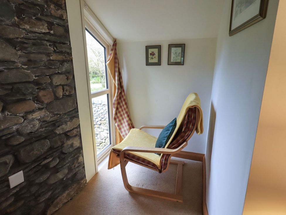 A snug area with a chair and window at Beckside Studio in Penrith