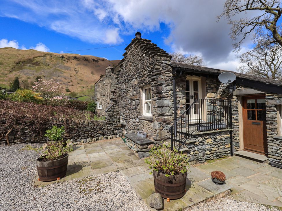 A stone cottage with steps and a door at Beckside Studio in Penrith