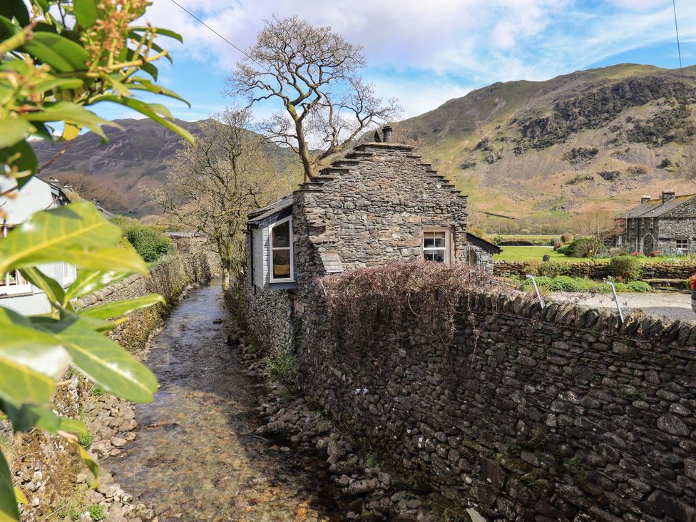 A stone building beside a stream in a rural setting at Beckside Studio Penrith