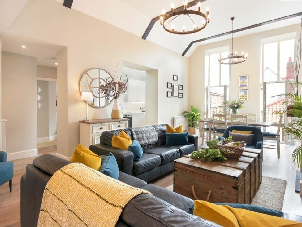 A living room with a sofa and coffee table at Juniper Cottage