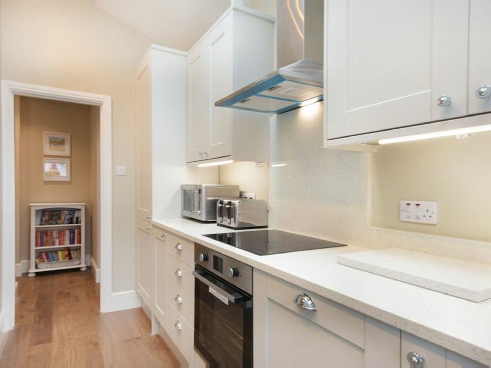 A kitchen with a microwave and oven at Juniper Cottage