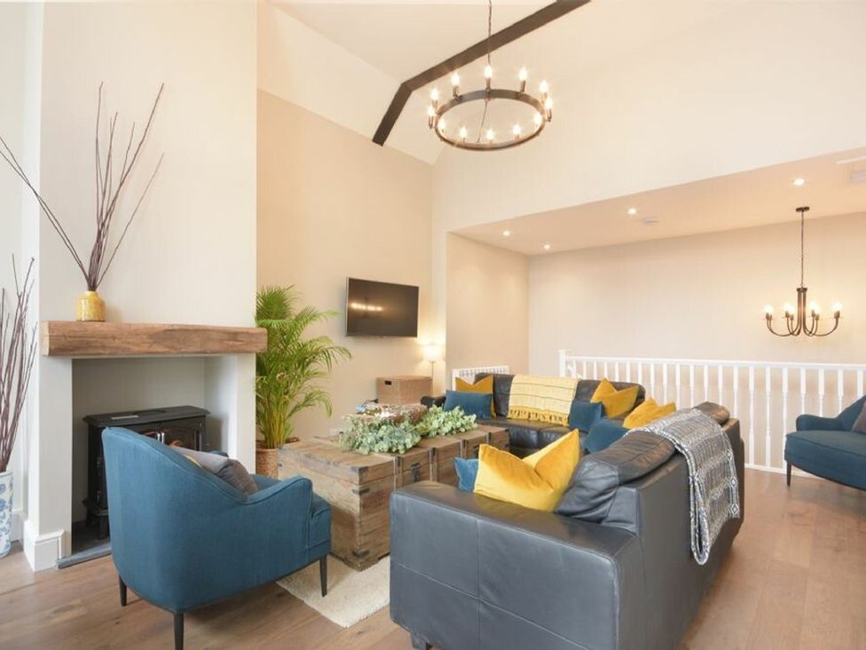 A living room with a sofa and coffee table at Juniper Cottage