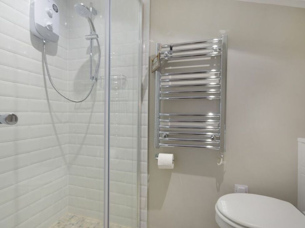 A bathroom with a shower and toilet at Juniper Cottage 
