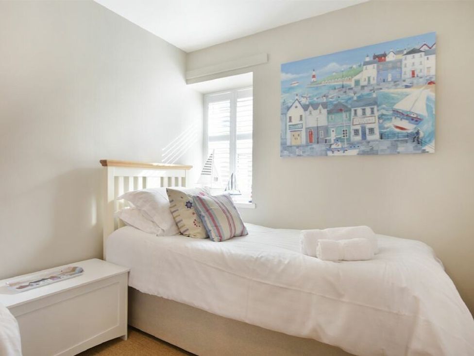 A bedroom with two beds and wall art at Juniper Cottage