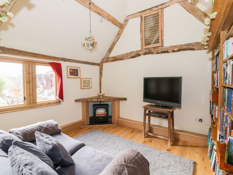 A living room with a sofa and television at Ryepiece in Stratford-upon-Avon