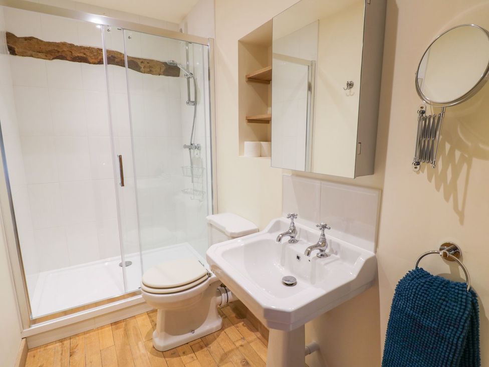 A bathroom with shower, toilet, sink, and mirror at Ryepiece Stratford-upon-Avon