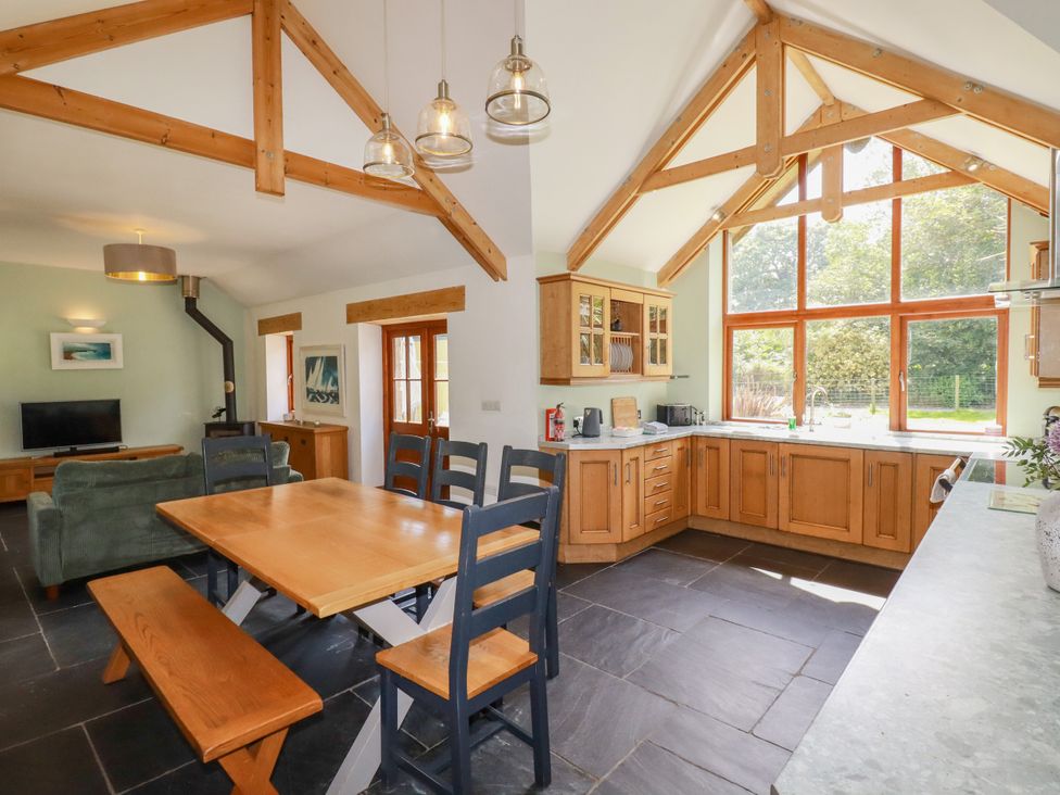 A kitchen with dining area and large windows at Little Trethellan in Trethellan near Lanner