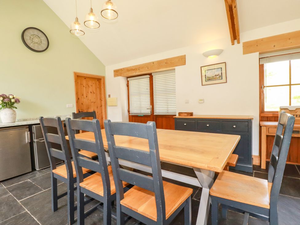 A kitchen with a table and chairs at Little Trethellan in Trethellan near Lanner