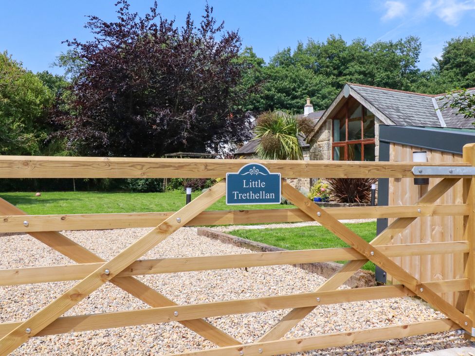 A wooden gate with a sign at Little Trethellan near Lanner