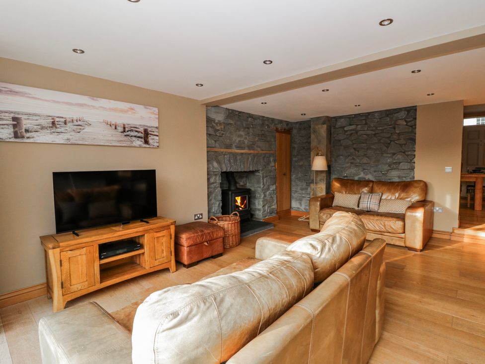 A living room with a sofa and television at Awelon Y Mor in Aberaeron