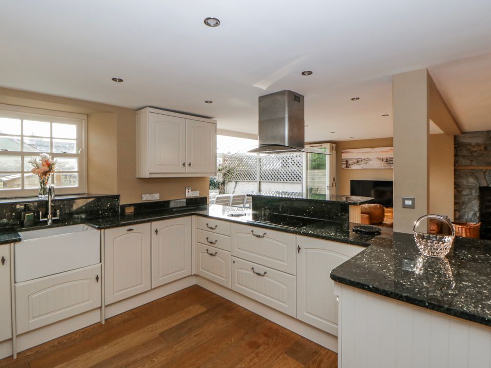 A kitchen with a sink and cabinets at Awelon Y Mor Aberaeron