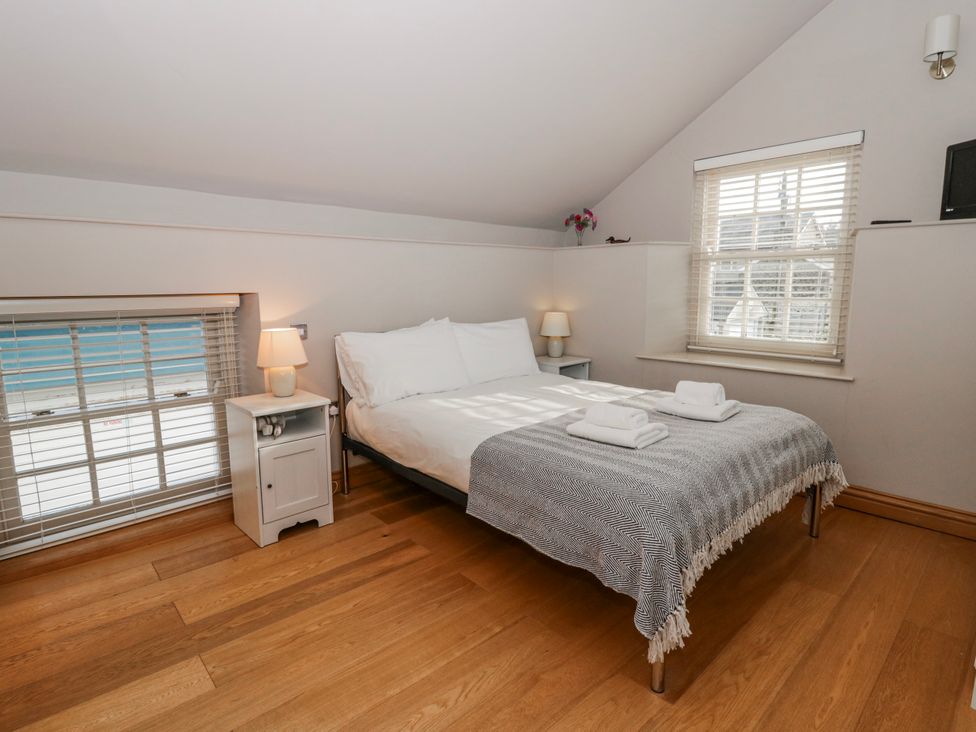 A bedroom with a bed and bedside table at Awelon Y Mor in Aberaeron