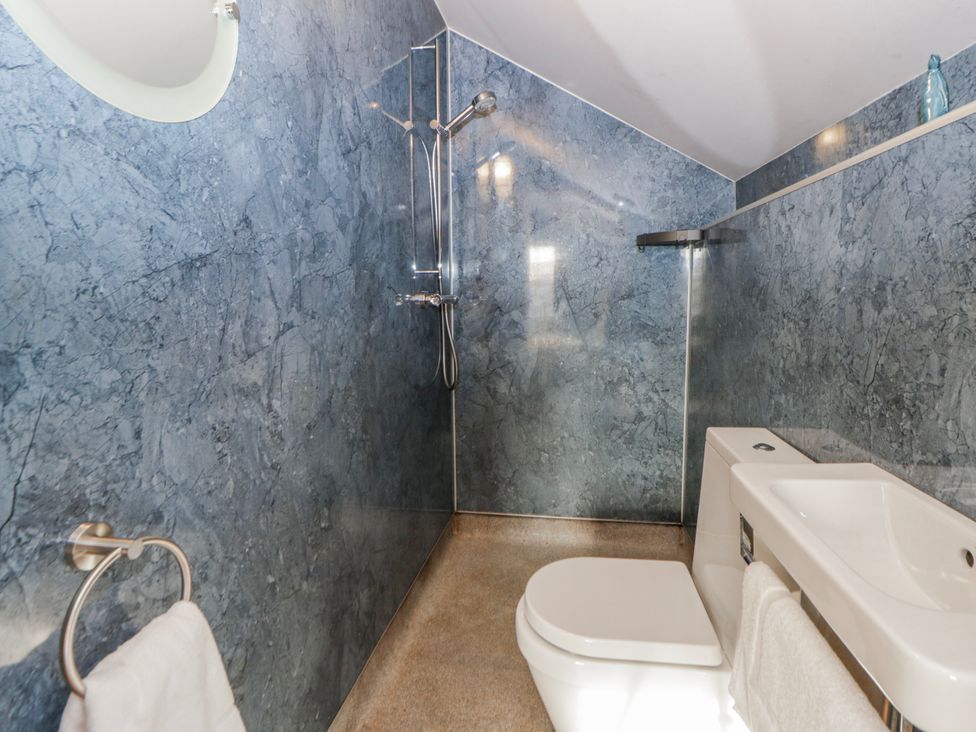 A bathroom with shower, toilet and sink at Awelon Y Mor in Aberaeron