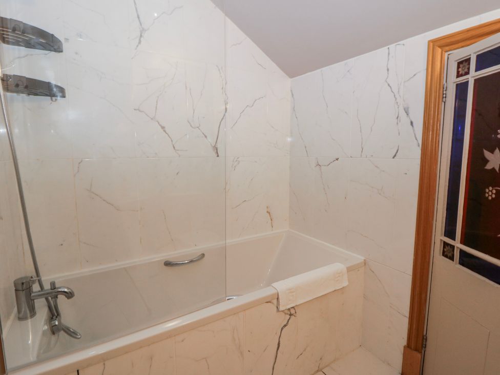 A bathroom with a bathtub and shower at Awelon Y Mor in Aberaeron