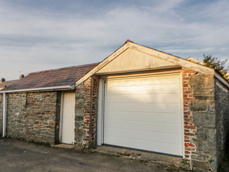 A garage with a stone and brick exterior at Awelon Y Mor in Aberaeron