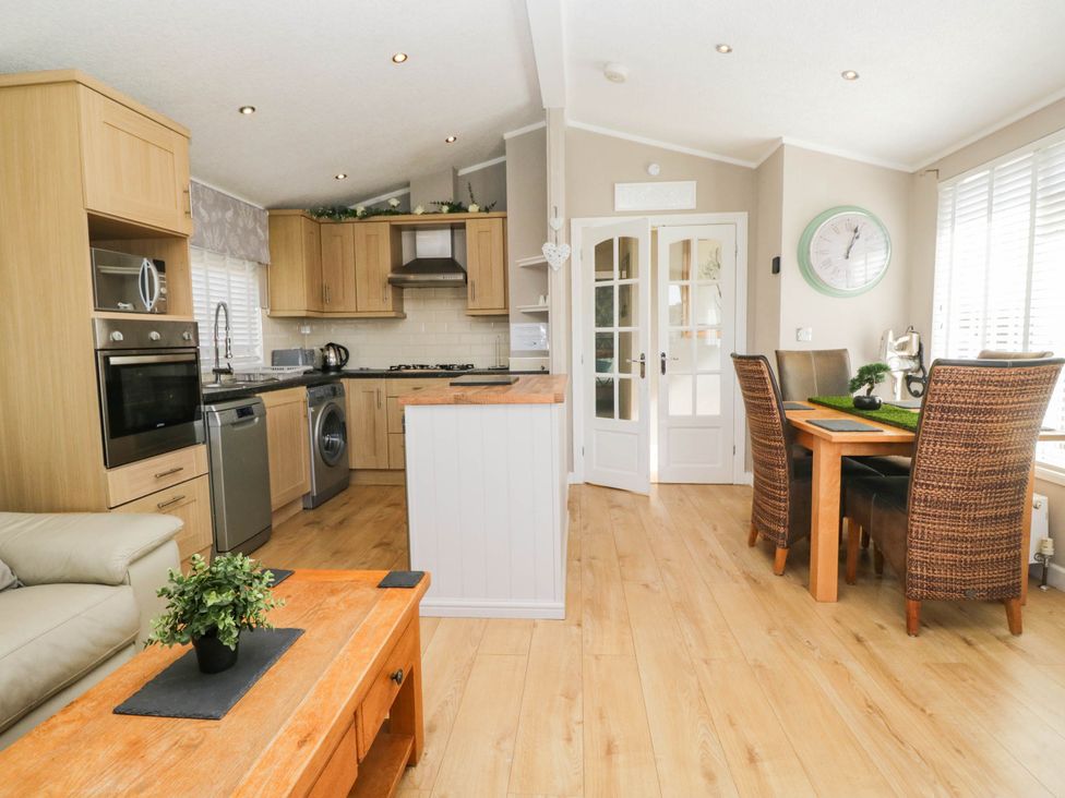 A kitchen with dining area and appliances at South lakeland Lodge. No. 46 Gressingham near Carnforth