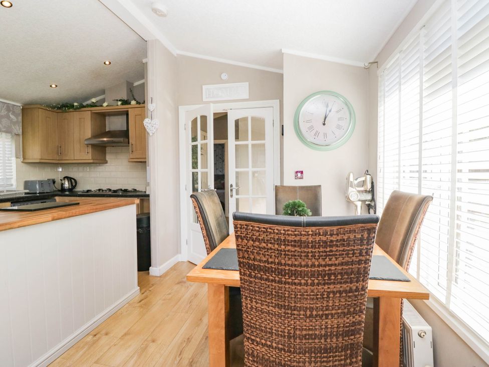 A dining area with table and chairs at South Lakeland Lodge. No. 46 Gressingham near Carnforth