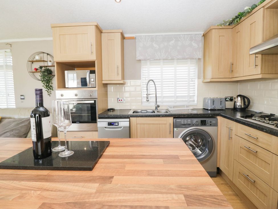 A kitchen with appliances and utensils at South Lakeland Lodge. No. 46 Gressingham near Carnforth