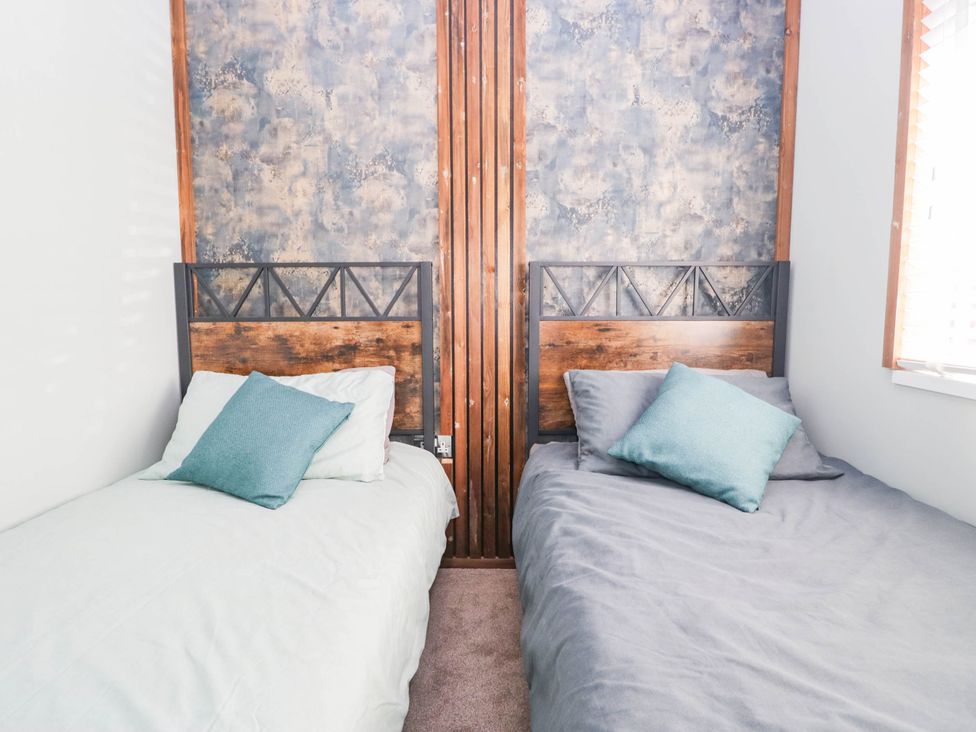 A bedroom with two single beds at South Lakeland Lodge. No. 46 Gressingham near Carnforth