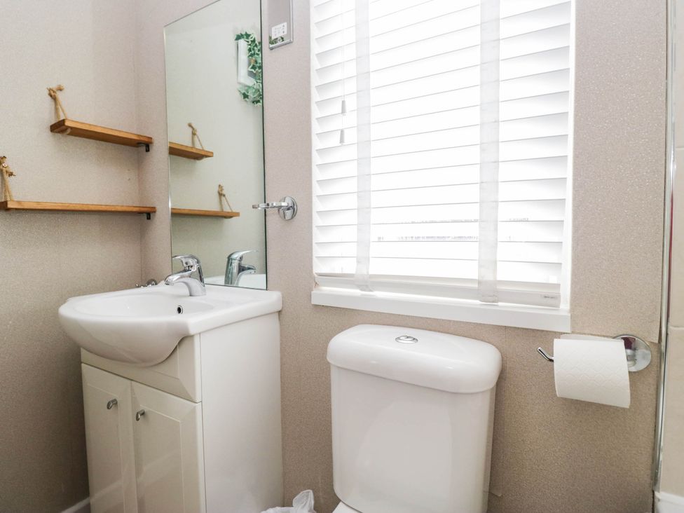 A bathroom with a sink and toilet at South lakeland Lodge. No. 46 Gressingham near Carnforth
