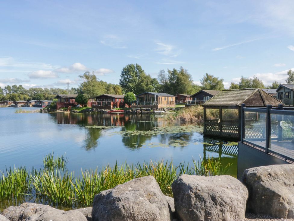 View of cabins by a lake at South lakeland Lodge. No. 46 Gressingham near Carnforth