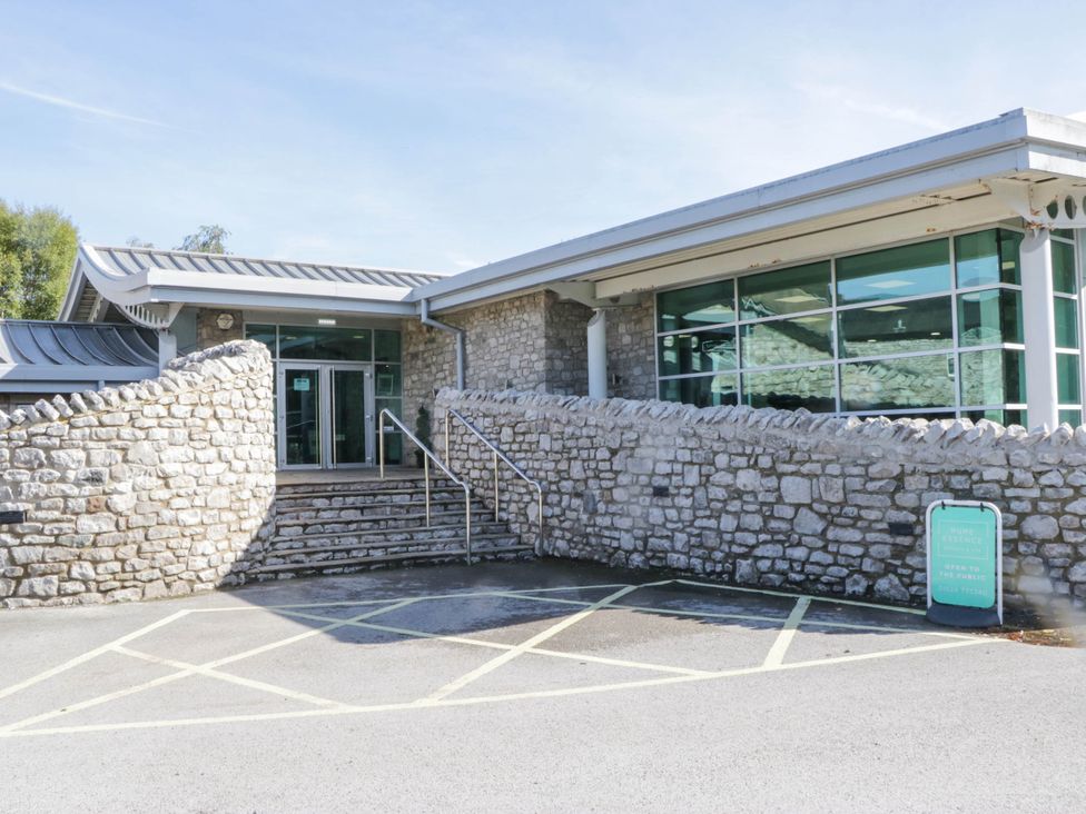 A building entrance with steps and a stone wall at South Lakeland Lodge. No. 46 Gressingham near Carnforth