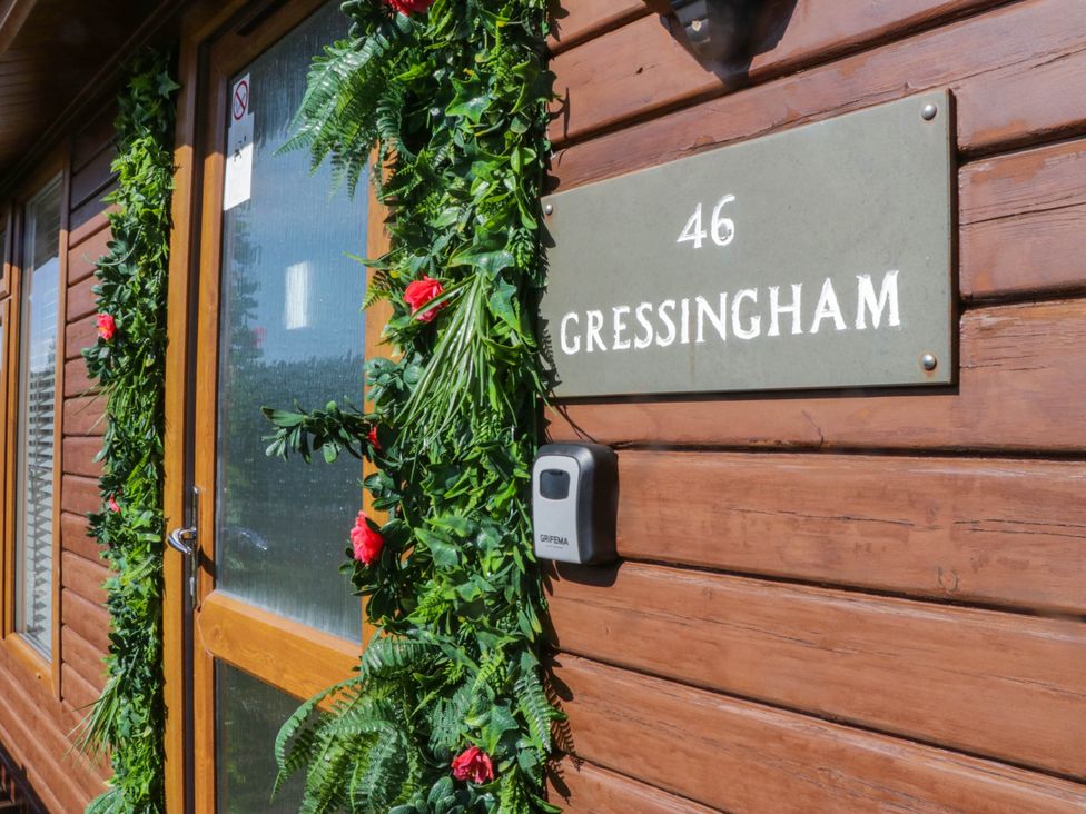 An entrance with a decorated door and nameplate at South Lakeland Lodge. No. 46 Gressingham near Carnforth