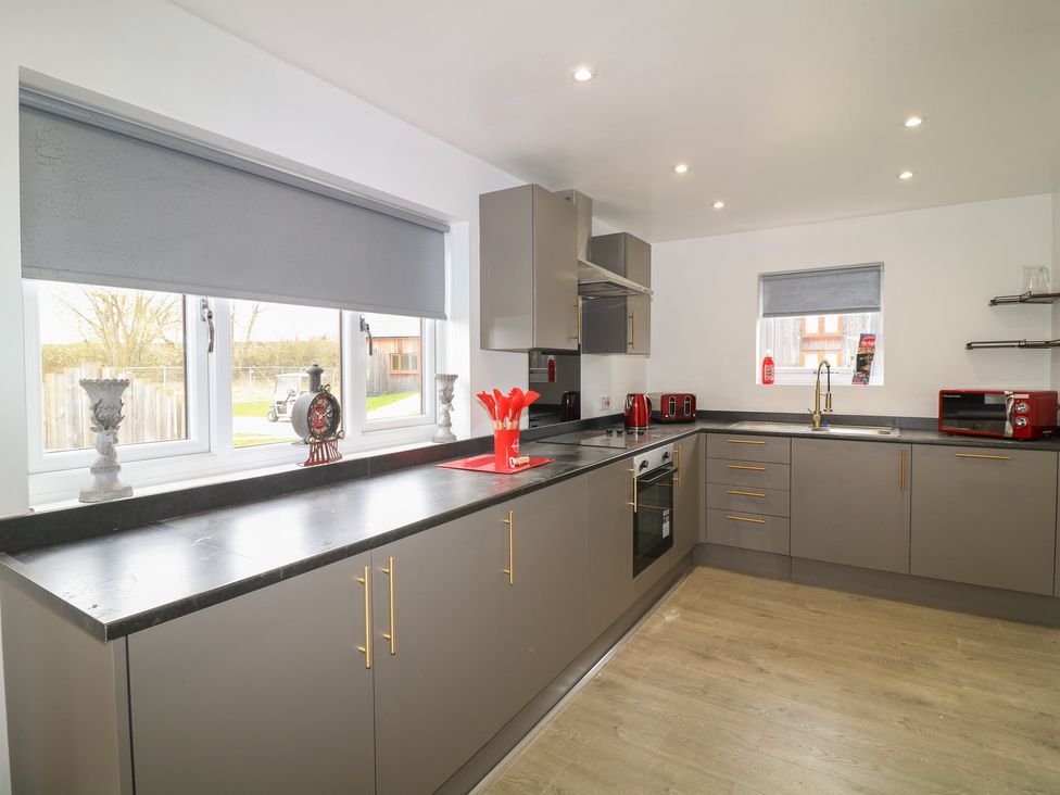A kitchen with cabinets and appliances at Ruby Red in Brigg